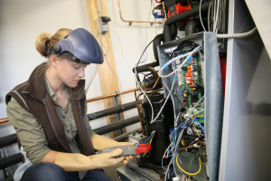 a woman working on a piece of equipment